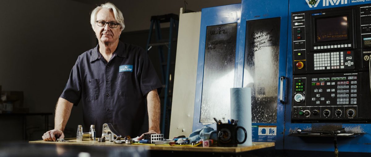 Bill Kibler next to CNC Machine